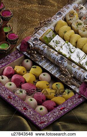 Sweet dishes and unlit diyas View Large Photo Image Stock Photo - Sweet dishes and unlit diyas. Fotosearch