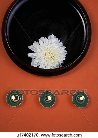 Stock Image - White flower and candles. Fotosearch