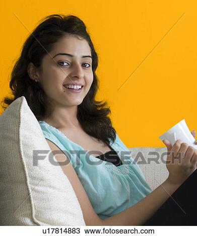 Stock Image - Woman drinking tea. Fotosearch