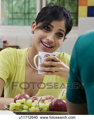 Stock Image - Woman having coffee. Fotosearch