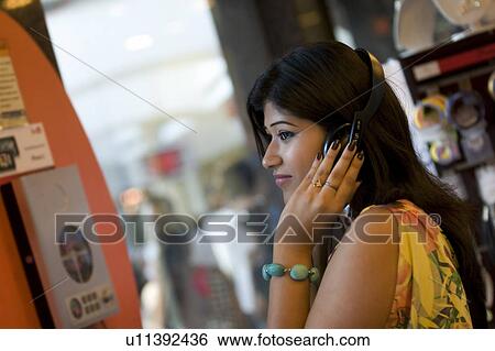 Stock Photograph - Woman listening to music. Fotosearch