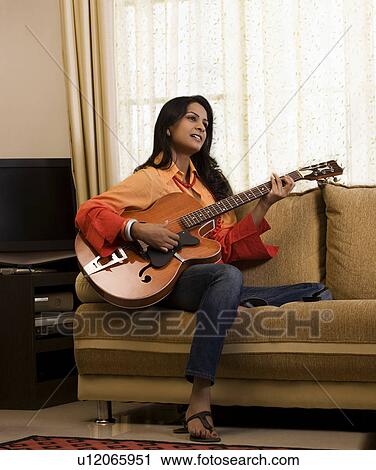 Woman playing the guitar View Large Photo Image Stock Image - Woman playing the guitar. Fotosearch