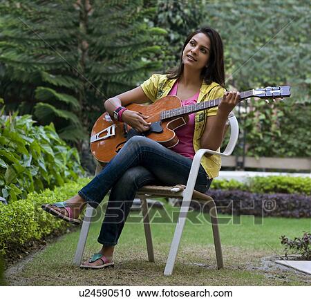 Stock Image - Woman playing the guitar. Fotosearch