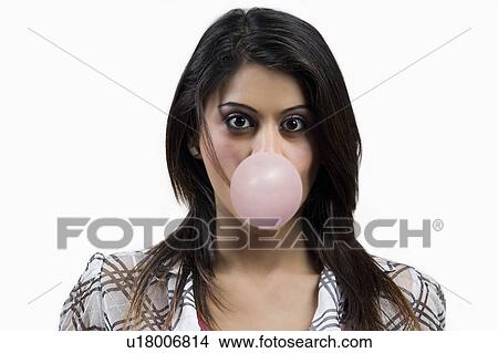 Young woman blowing a bubble View Large Photo Image Picture - Young woman blowing a bubble. Fotosearch