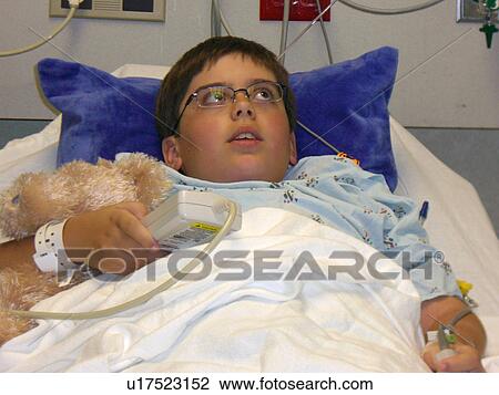 A boy watches TV before surgery. View Large Photo Image Stock Image - A boy watches TV before surgery.. Fotosearch