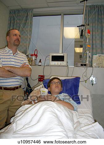 A boy watches TV before surgery. View Large Photo Image Stock Photograph - A boy watches TV before surgery.. Fotosearch