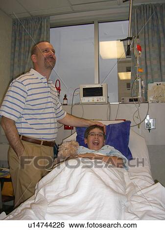 A boy watches TV before surgery. View Large Photo Image Stock Photograph - A boy watches TV before surgery.. Fotosearch