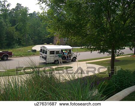 Stock Photo - A boy, who uses a wheelchair, exits a bus via a ramp.. Fotosearch