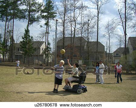 A boy, who uses a wheelchair, plays tether ball with some friends at recess. View Large Photo Image Stock Photo - A boy, who uses a wheelchair, plays tether ball with some friends at recess.. Fotosearch
