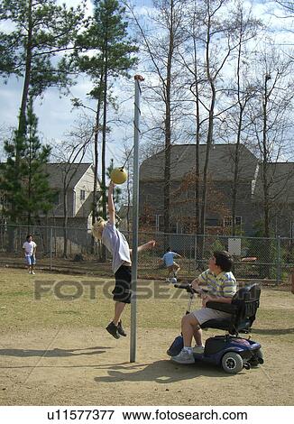A boy, who uses a wheelchair, watches one of his friends play tether ball. View Large Photo Image Stock Photo - A boy, who uses a wheelchair, watches one of his friends play tether ball.. Fotosearch