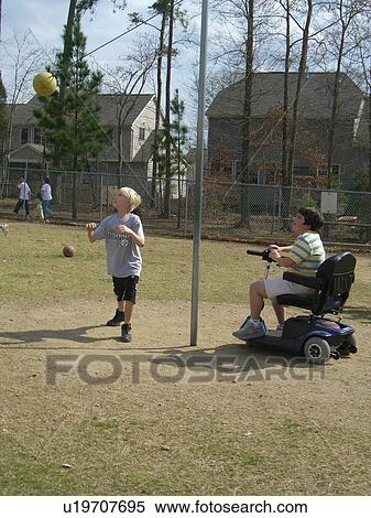 A boy, who uses a wheelchair, watches one of his friends play tether ball. View Large Photo Image Stock Photography - A boy, who uses a wheelchair, watches one of his friends play tether ball.. Fotosearch