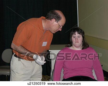 Stock Photo - A girl gets her teeth checked.. Fotosearch