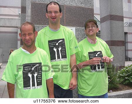 Stock Photograph - A group of friends enjoy a hello after a long time being apart.. Fotosearch