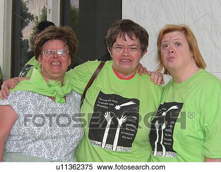 Stock Photography - A group of friends enjoy a hello after a long time being apart.. Fotosearch