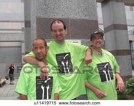 Stock Photography - A group of friends enjoy a hello after a long time being apart.. Fotosearch