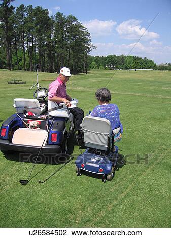 A man teaches a woman, who uses a wheelchair, how to play golf. View Large Photo Image Stock Image - A man teaches a woman, who uses a wheelchair, how to play golf.. Fotosearch