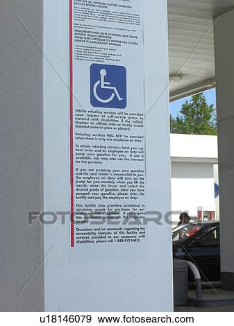 Stock Photo - A sign at a gas station for people that may need help filling up their cars with gas.. Fotosearch
