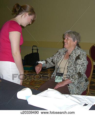 A woman greets another woman. View Large Photo Image Stock Image - A woman greets another woman.. Fotosearch