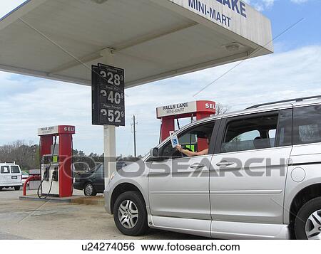 Stock Photograph - A woman holds a handicap parking permit.. Fotosearch
