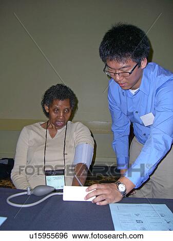 A woman waits for her blood pressure. View Large Photo Image Stock Photograph - A woman waits for her blood pressure.. Fotosearch