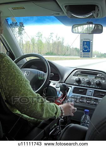 A woman, who uses a handicap parking permit, drives her van down the highway. View Large Photo Image Stock Image - A woman, who uses a handicap parking permit, drives her van down the highway.. Fotosearch