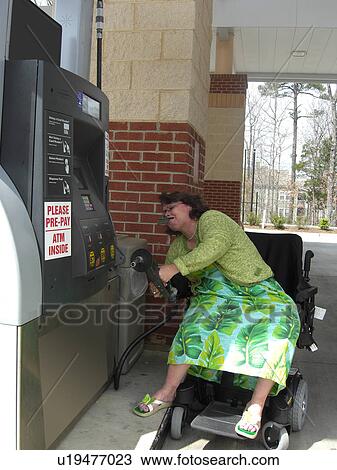 A woman, who uses a wheelchair, fills her car up with gas. View Large Photo Image Stock Image - A woman, who uses a wheelchair, fills her car up with gas.. Fotosearch