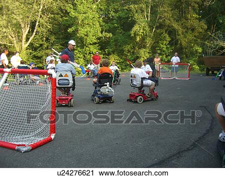 Stock Image - Street Hockey at Muscular Dystrophy camp.. Fotosearch