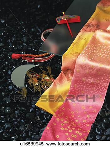 Stock Photography - A belt, a hand mirror, and a hair pin, laid out on stone surface. Fotosearch