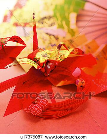 A folded paper crane, mizuhiki, and a fan View Large Photo Image Stock Photo - A folded paper crane, mizuhiki, and a fan. Fotosearch