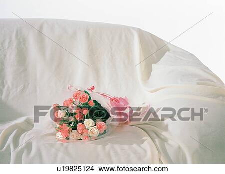 Bouquet of roses on a sofa View Large Photo Image Picture - Bouquet of roses on a sofa. Fotosearch