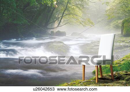 Stock Image - Chair by a flowing river. Fotosearch