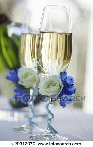 Stock Image - Champagne flutes decorated with flowers. Fotosearch