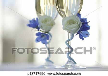 Stock Image - Champagne glasses decorated with flowers. Fotosearch