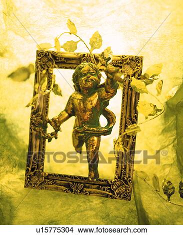 Cherub picture frame wrapped in ivy View Large Photo Image Picture - Cherub picture frame wrapped in ivy. Fotosearch