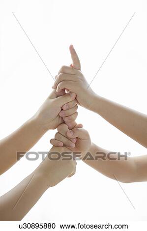 Children piling up fists, white background View Large Photo Image Stock Image - Children piling up fists, white background. Fotosearch