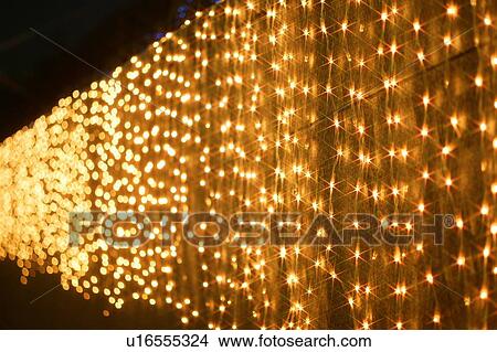 Christmas lights hanging over a wall View Large Photo Image Picture - Christmas lights hanging over a wall. Fotosearch