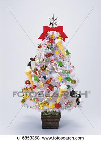 Stock Photo - Christmas tree covered in decorations. Fotosearch
