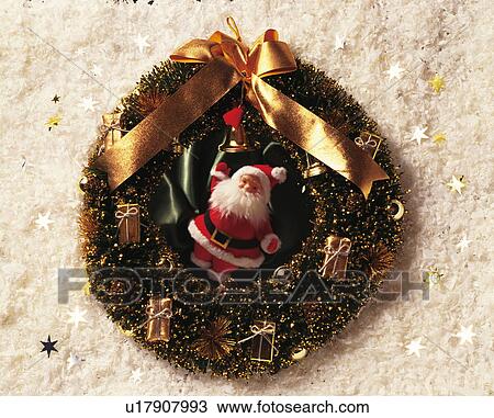 Stock Image - Christmas wreath on a bed of artificial snow surrounded by Christmas stars. Fotosearch