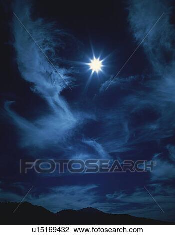 Stock Image - Cirrus cloud over landscape. Fotosearch