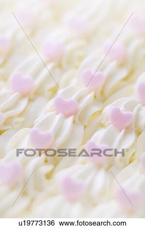 Stock Photograph - Close up of cream decorations, full frame. Fotosearch