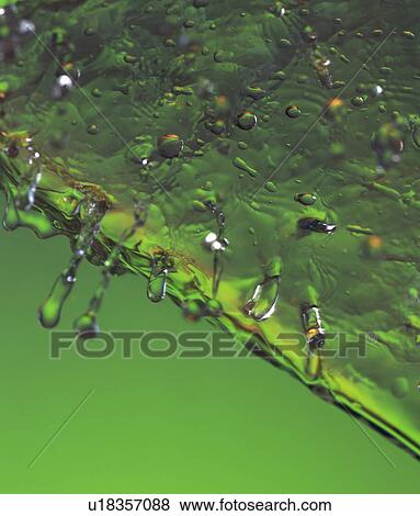 Stock Photo - Close up of water melting off ice cube. Fotosearch