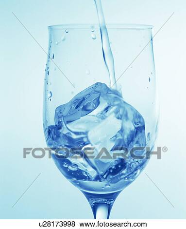 Stock Photo - Cocktail being poured over ice into a wineglass. Fotosearch