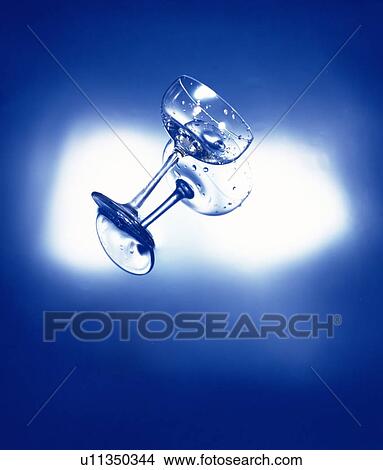 Cocktail glass floating on water View Large Photo Image Picture - Cocktail glass floating on water. Fotosearch