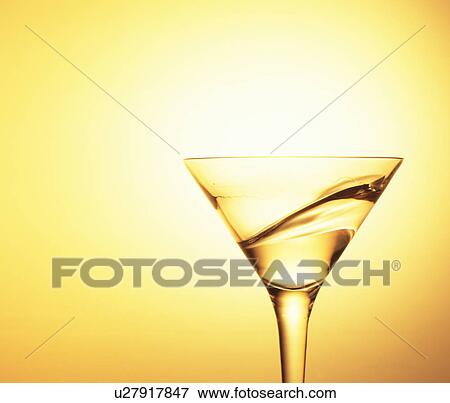 Stock Photo - Cocktail swirling in a martini glass . Fotosearch