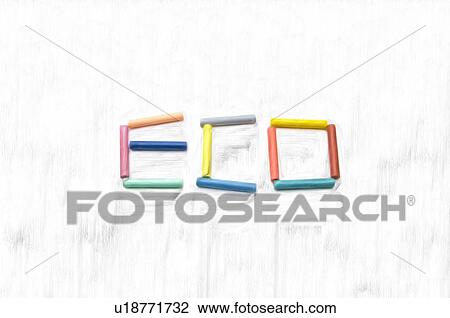 Stock Image - Colorful chalk sticks spelling ECO, white background. Fotosearch
