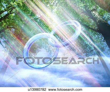 Composite image depicting two wedding rings intertwined, with a forest, a cloudscape and god-like rays View Large Photo Image Stock Image - Composite image depicting two wedding rings intertwined, with a forest, a cloudscape and god-like rays. Fotosearch