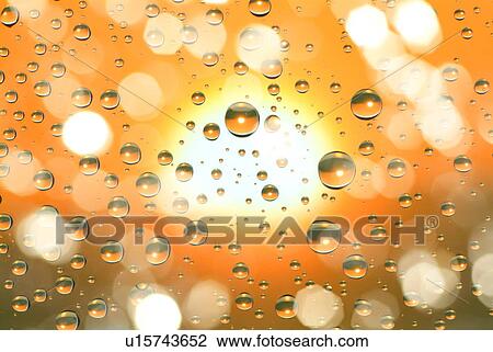 Stock Image - Condensation on window pane with solar flare. Fotosearch