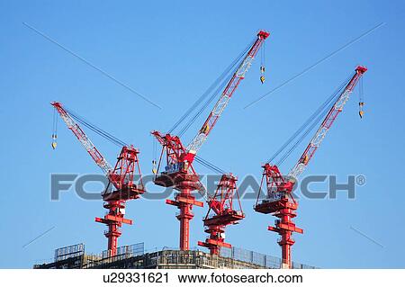 Cranes on a construction site View Large Photo Image Stock Image - Cranes on a construction site. Fotosearch