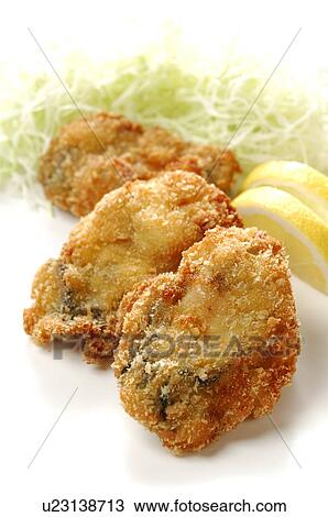 Stock Image - Deep fried oysters, close up, white background. Fotosearch