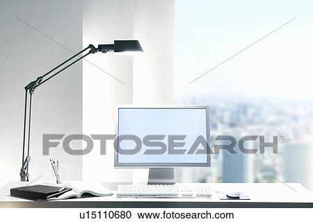Desk lamp and computer on desk with view of a city through the window View Large Photo Image Stock Image - Desk lamp and computer on desk with view of a city through the window. Fotosearch